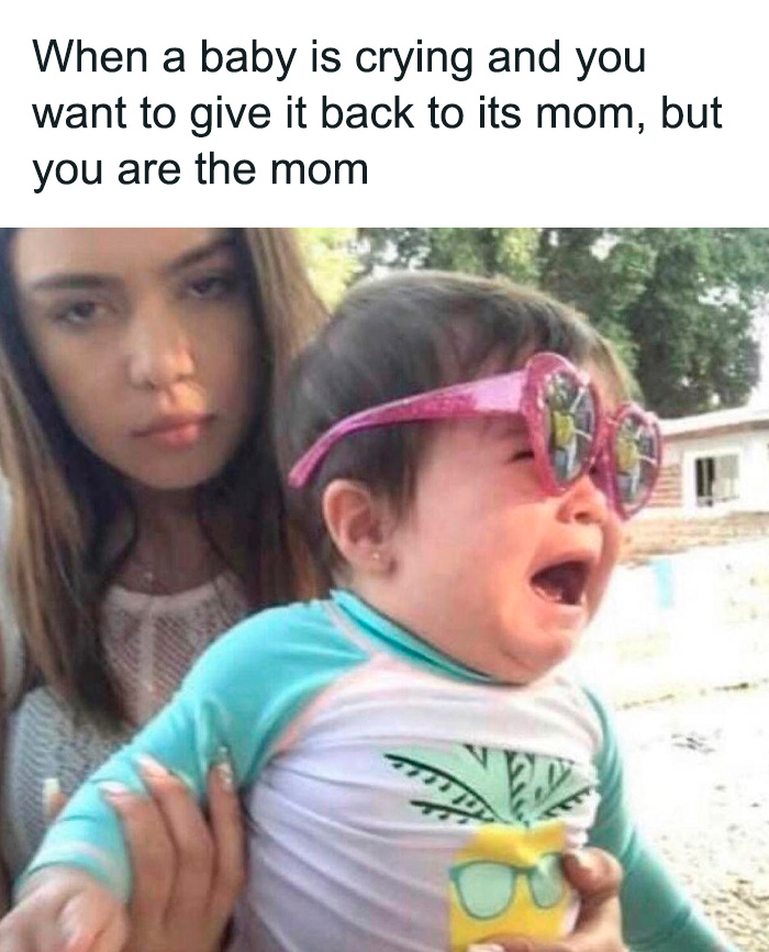 Mom holding a crying baby with sunglasses in a humorous parenting meme.