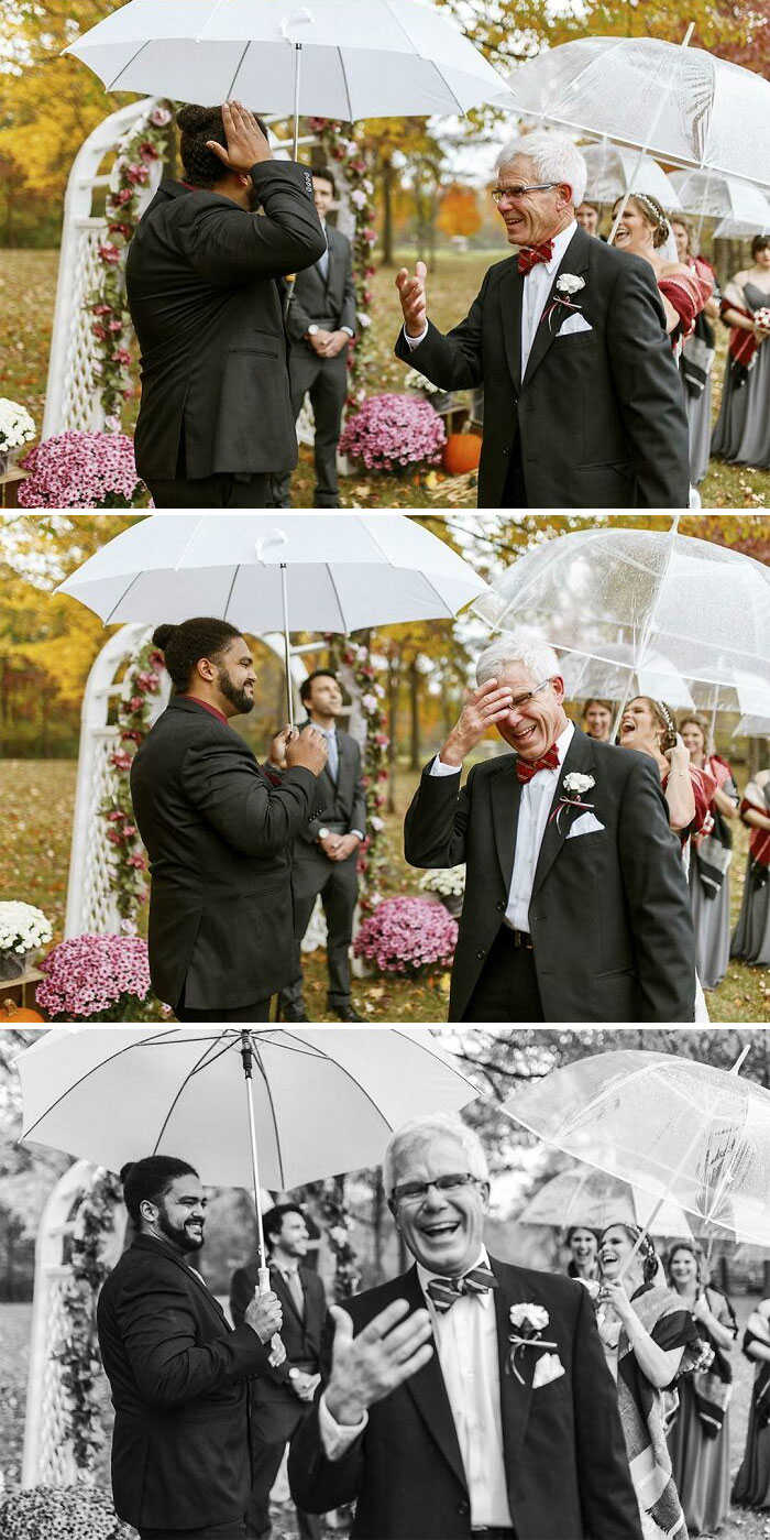 Elderly man laughing with in-laws under umbrellas at a wedding.