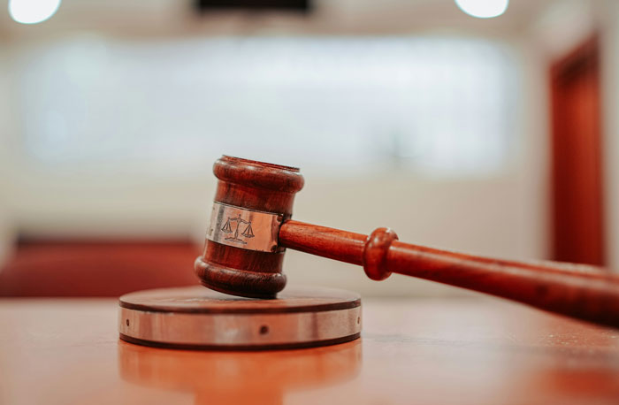 Judge's gavel on a courtroom desk, symbolizing surprising speeding reasons shared with officers.