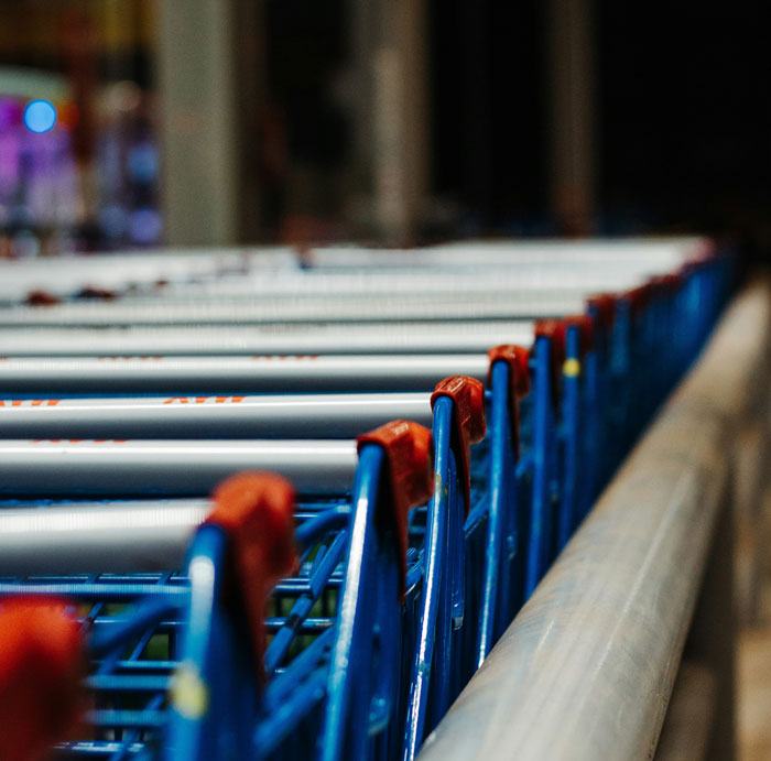 Rows of shopping carts lined up in a retail store setting, highlighting reasons people have been fired.