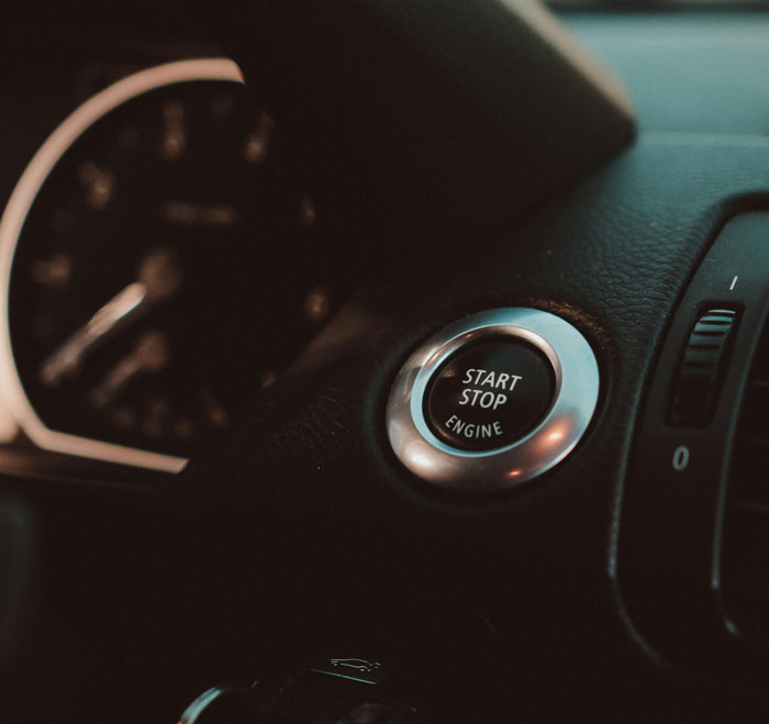 Car dashboard with start-stop button, symbolizing genuine speeding reasons shared with officers.