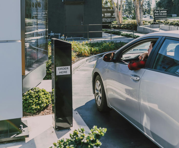 A car at a drive-thru order station, illustrating reasons for being fired.