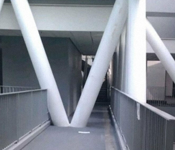 Construction fail with misplaced support beam blocking the walkway.