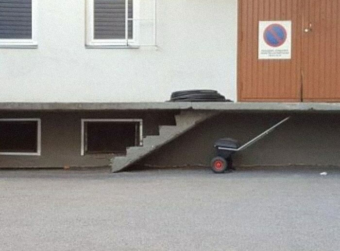 Construction fail with incomplete stairs leading to a wall, illustrating a humorous oversight.