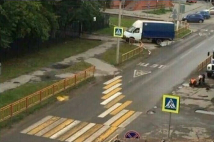 Construction fail: Misaligned pedestrian crosswalk leading to a blocked path with a truck stranded on the sidewalk.