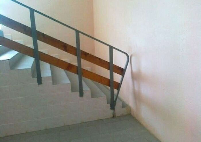 Construction fail with misaligned railing on stairs.