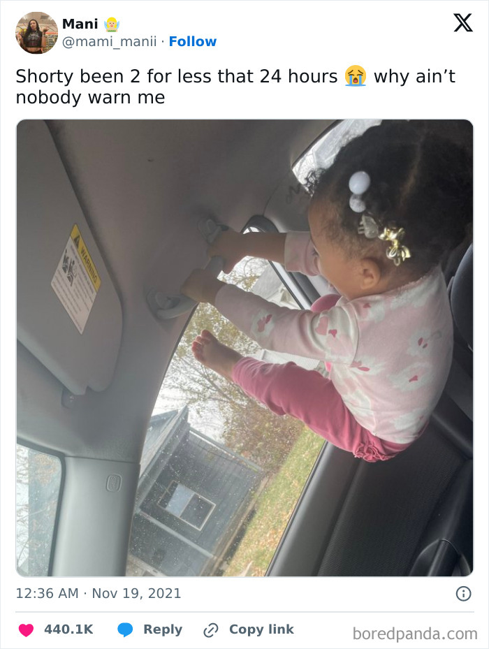 Toddler hanging from car handle, creating a funny fail moment.