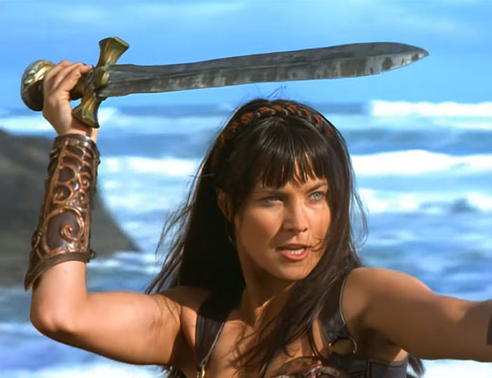 A strong female protagonist wielding a sword by the ocean, showcasing empowerment and strength.