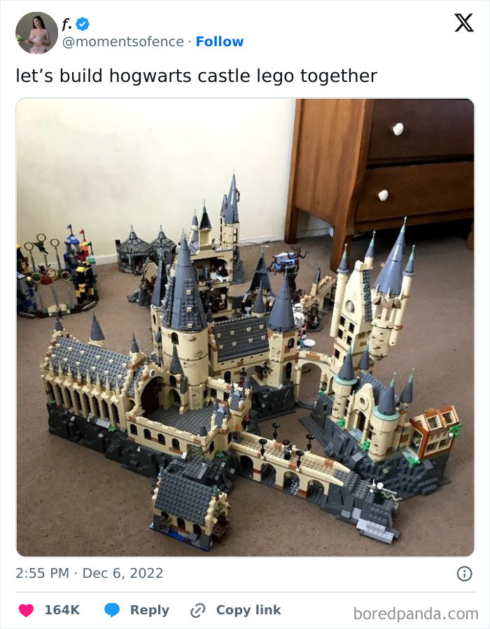 Hogwarts Castle cool LEGO build on a carpeted floor next to a wooden dresser.