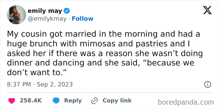 Tweet from emilykmay about a wedding with brunch instead of dinner, highlighting a funny and spot-on reply.