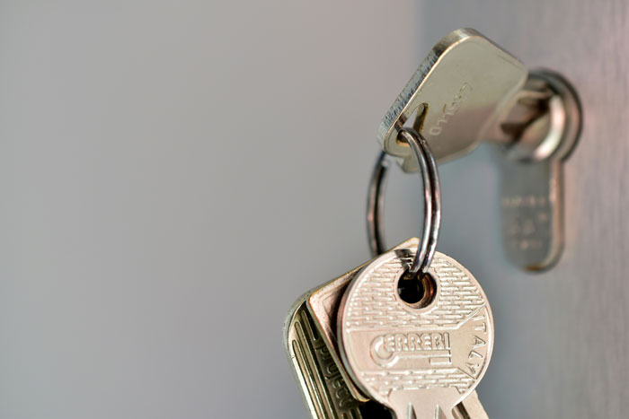 Keys in a door lock highlighting important security measures.