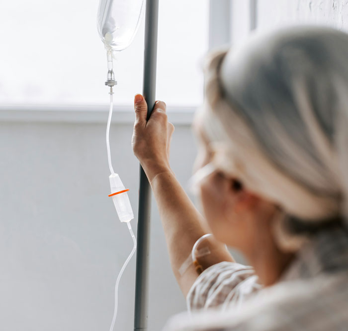 Person adjusting an IV drip in a hospital setting, related to reasons they’ve been fired.