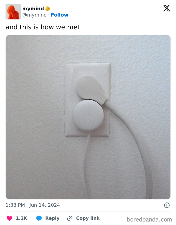 White plug perfectly fit into a socket on a white wall, showcasing satisfying alignment.