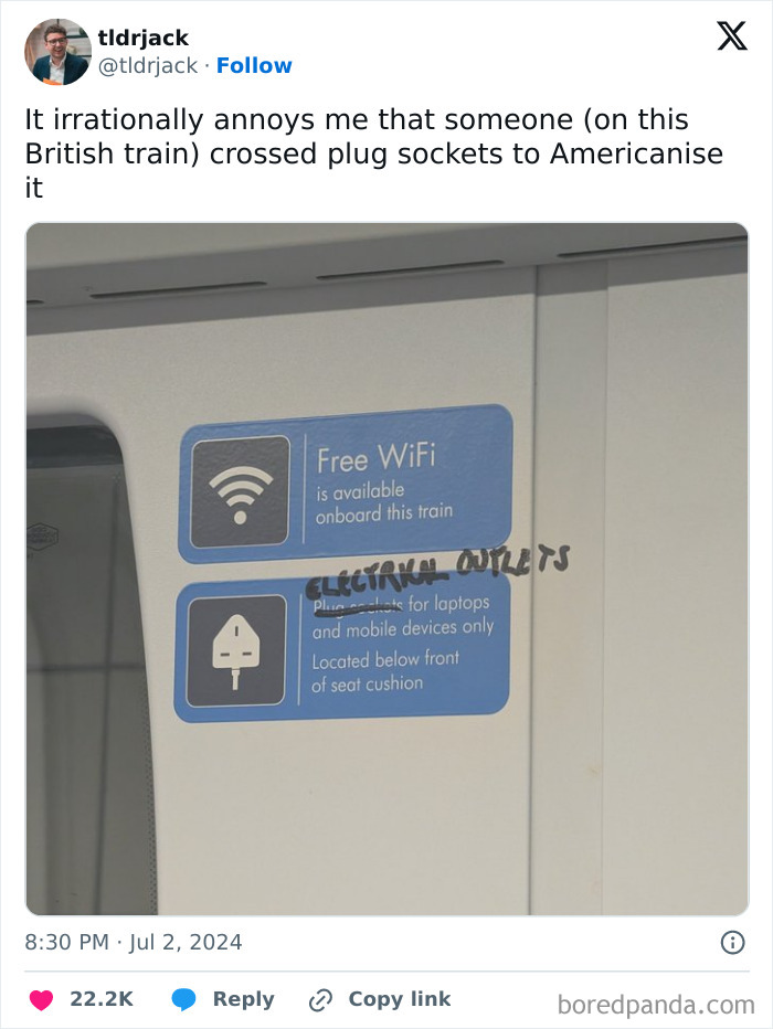 Sign on British train with "electrical outlets" handwritten above plug socket icon.