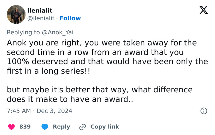 Tweet discussing a model's award loss, reflecting on deserving recognition and questioning the value of awards.