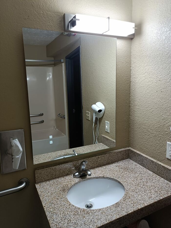 Bathroom mirror placed too high, a funny construction fail above the sink.