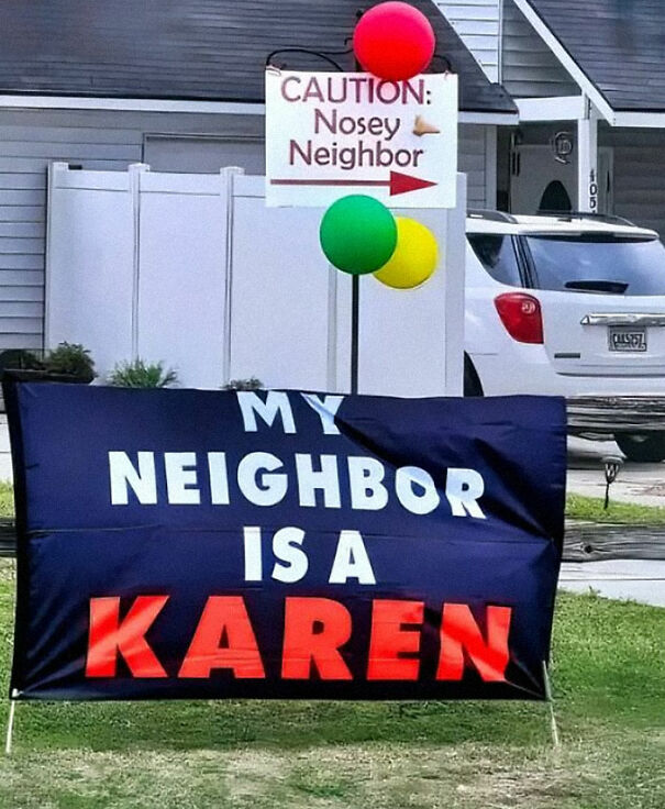 Weird sign on front lawn reads "My Neighbor is a Karen," with balloons and caution note for nosey neighbors.