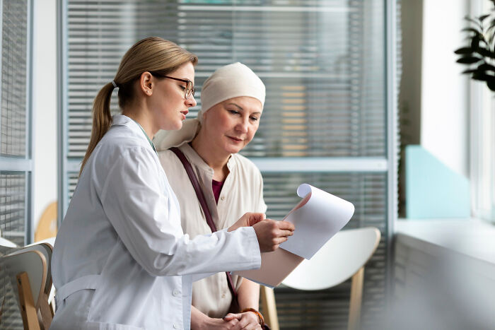 Doctor discussing documents with a patient, highlighting a difficult Christmas experience.