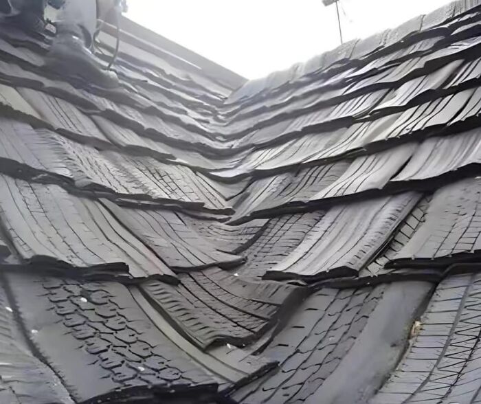 Roof made of layered rubber tires showcasing a humorous cheap construction fail.