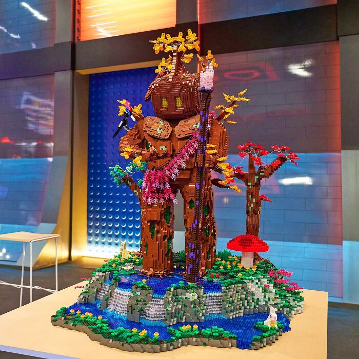 Intricate LEGO build depicting a fantasy tree creature with colorful foliage and detailed landscape, showcasing cool LEGO creativity.