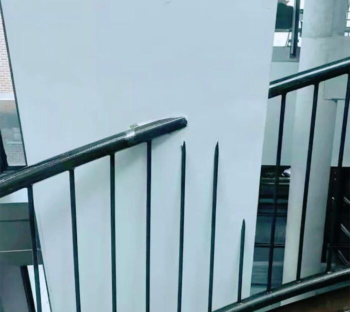 Funny cheap construction fail with a staircase railing leading directly into a wall.