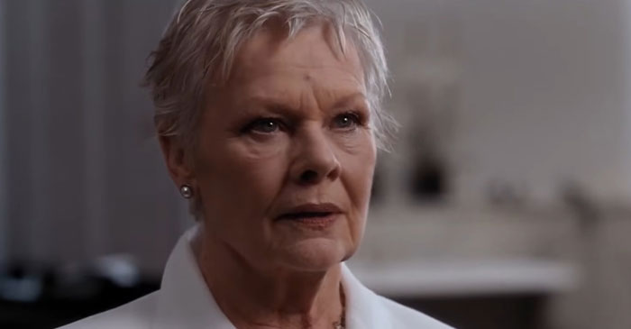 An older woman with short hair, exemplifying a strong female protagonist in a serious setting.