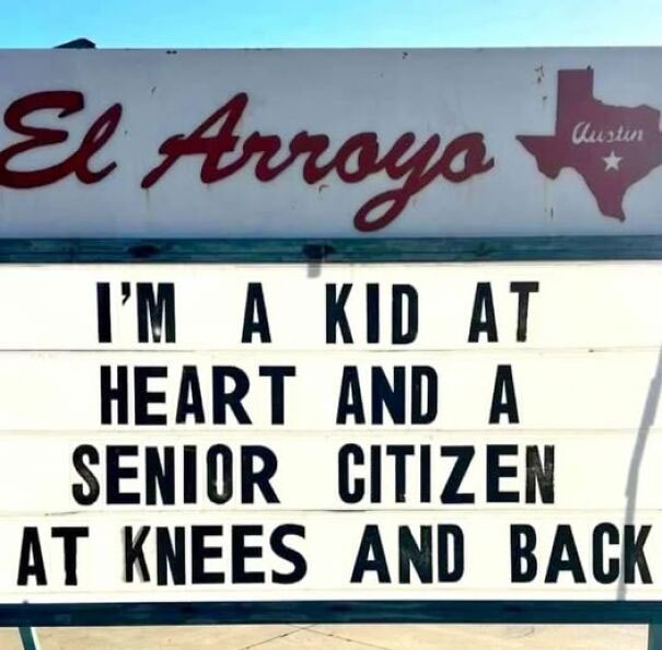 Weird and absurd sign reading "I'm a kid at heart and a senior citizen at knees and back" at El Arroyo, Austin.