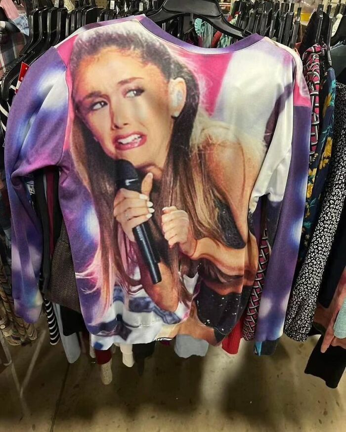 A colorful weird-shirt featuring a disgusted Ariana Grande's face displayed on a rack.