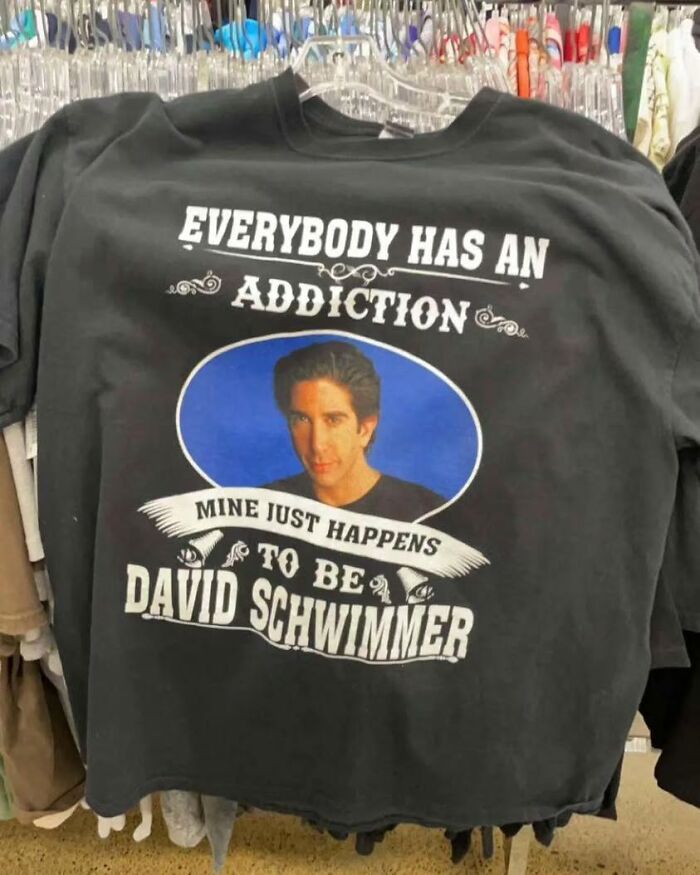 Black shirt with text "Everybody has an addiction, mine just happens to be David Schwimmer." Features a photo of him.