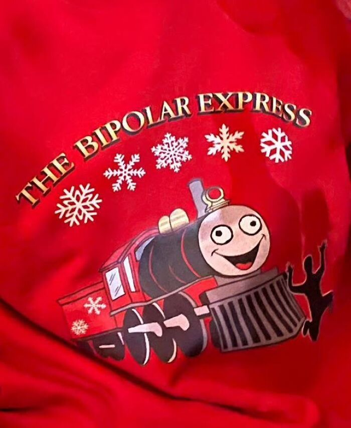 Red shirt with quirky train design and snowflakes, featuring text "The Bipolar Express" for weird-shirts.