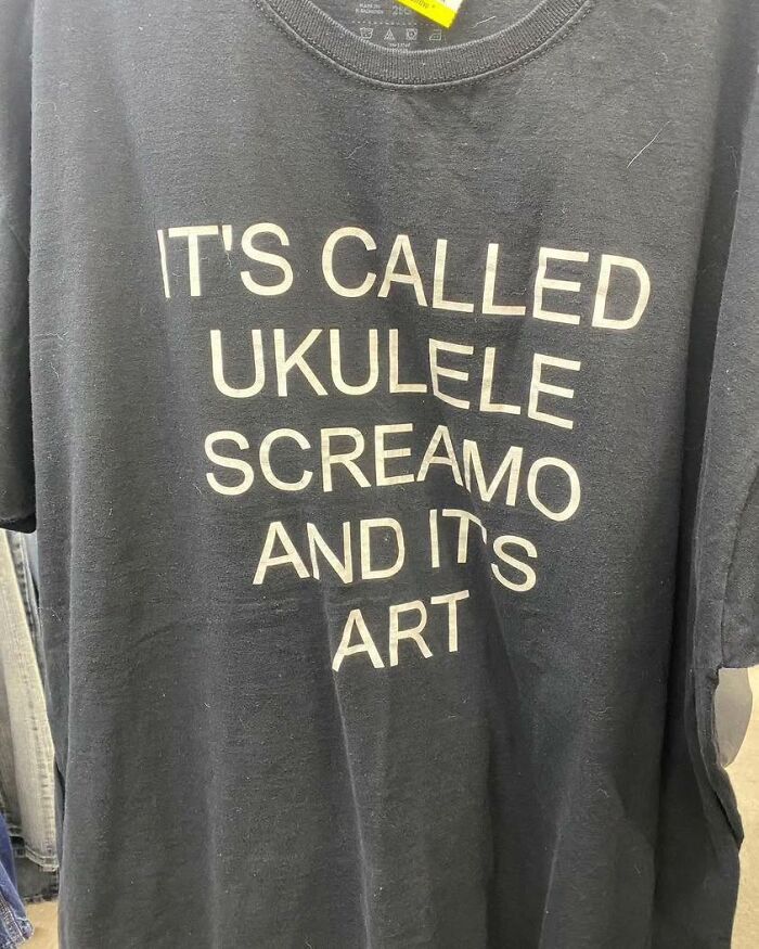 Black shirt with white text saying, "It's called ukulele screamo and it's art."