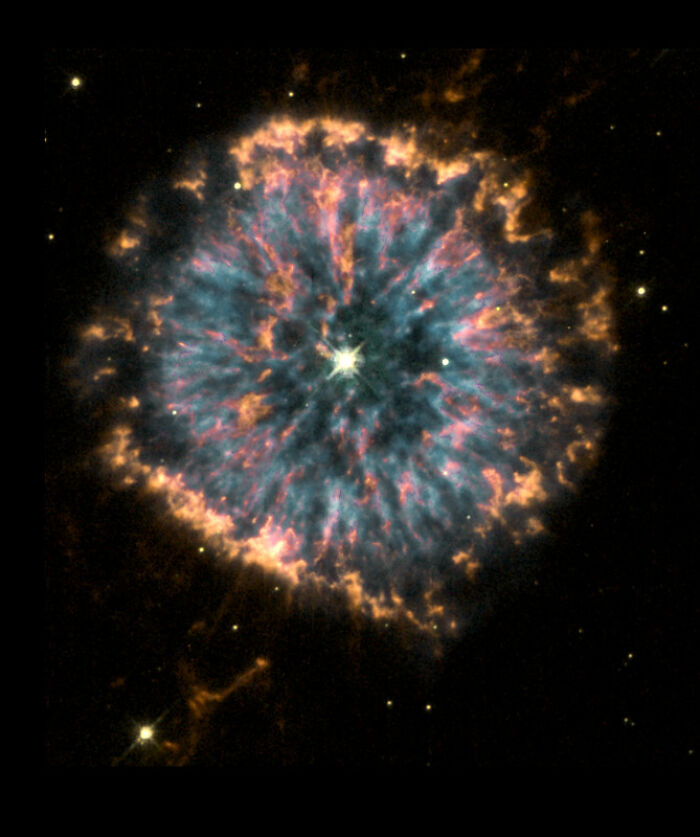 Colorful nebula with radiant star at center, showcasing vibrant cosmic beauty in space.