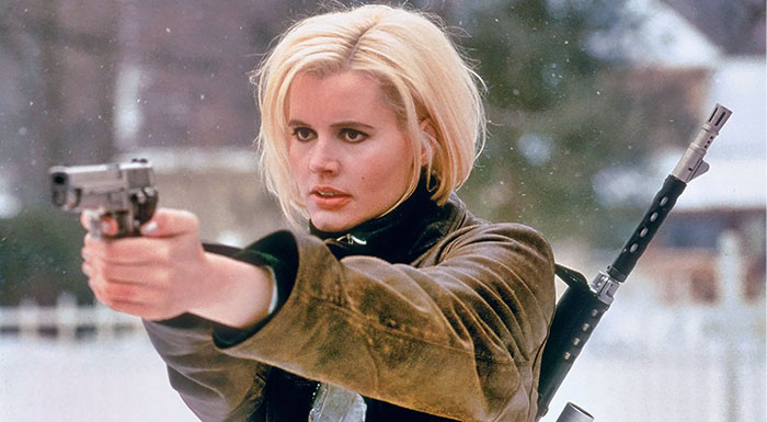 A strong female protagonist aiming a gun with determination, showing courage and strength in a winter setting.