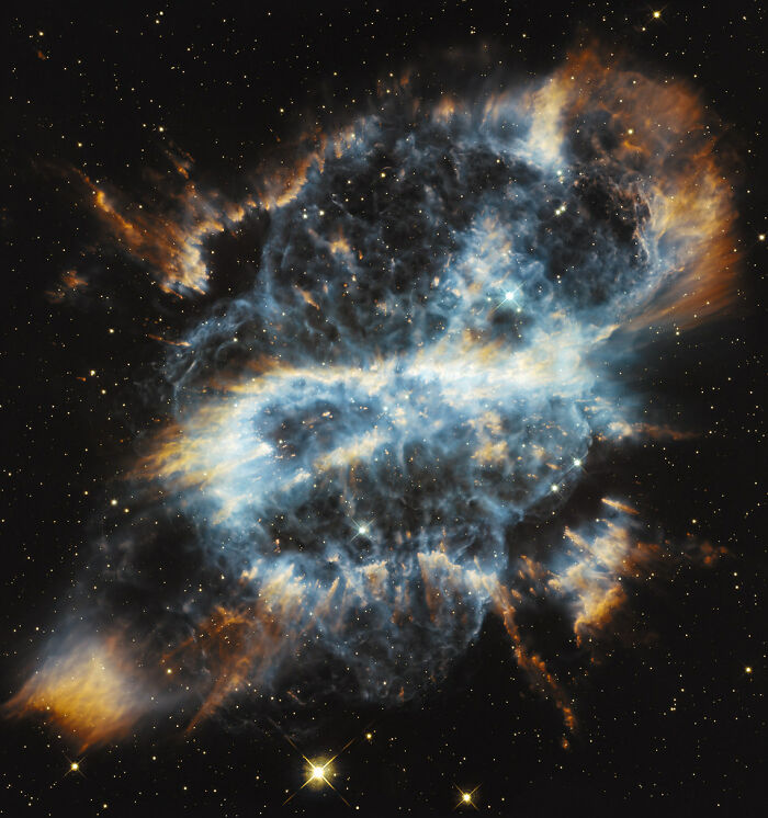 Amazing nebula image showcasing vibrant blue, orange, and white gas clouds against a starry space background.