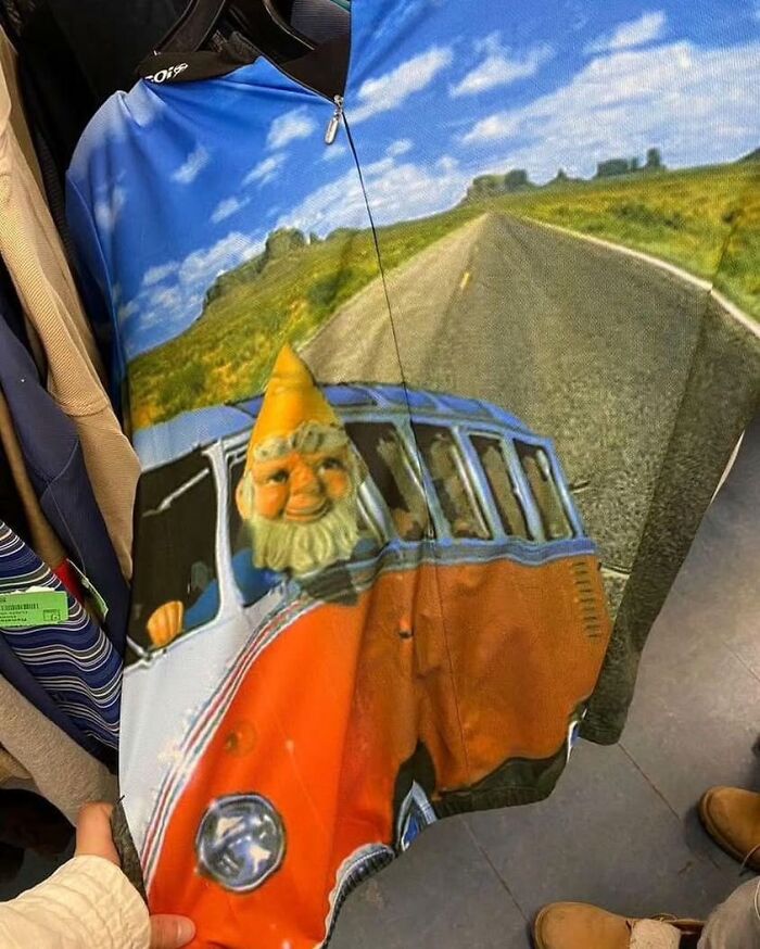 Weird shirt featuring a gnome driving a vintage van on a scenic road backdrop.