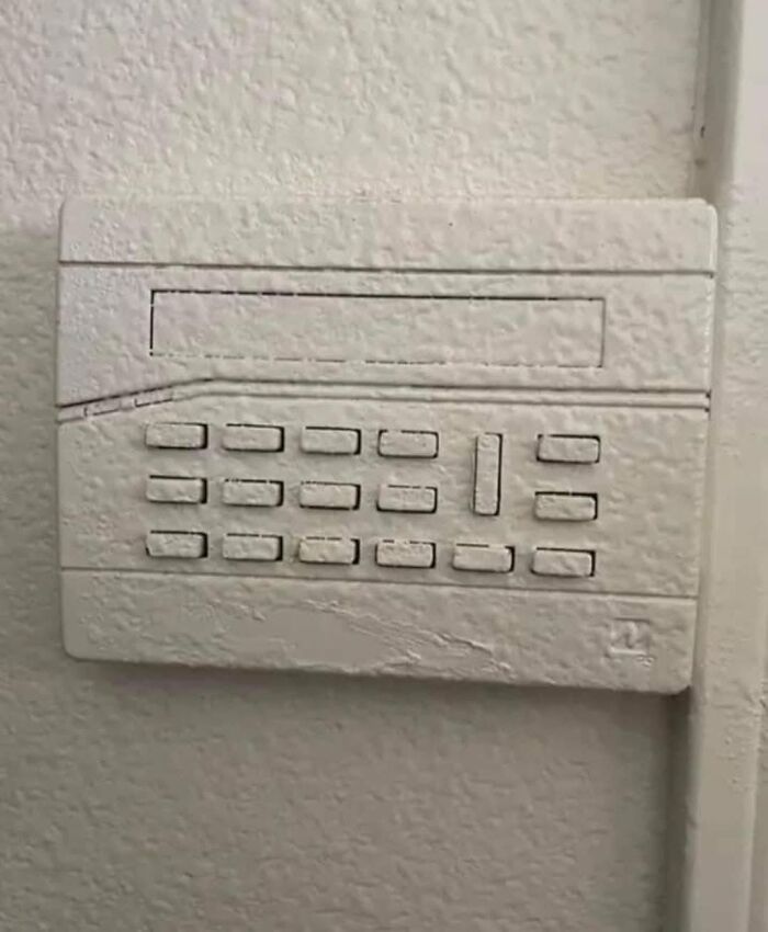 Painted-over keypad on a wall, showcasing a cheap construction fail.