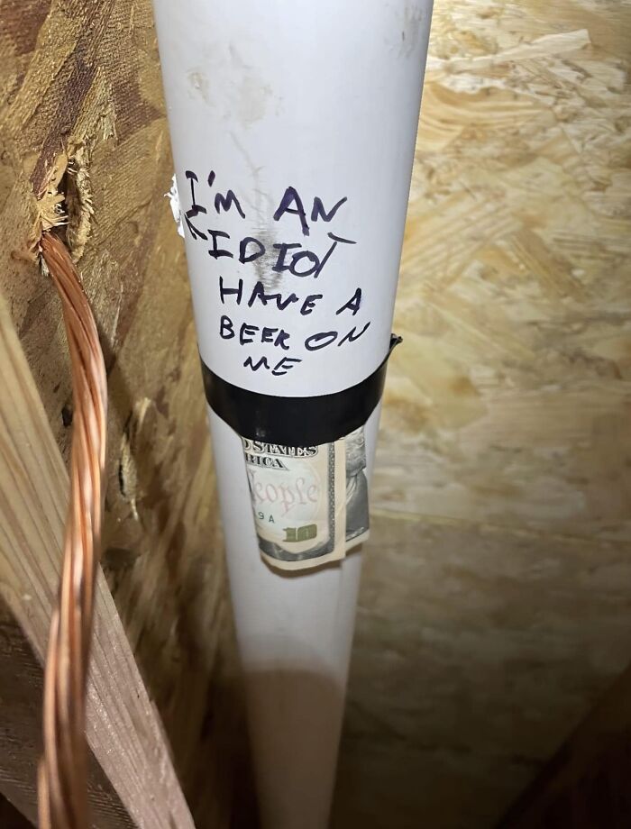 Funny cheap construction fail with a pipe labeled "I'm an idiot, have a beer on me" and money taped to it.