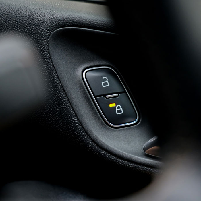 Close-up of a car lock button, highlighting security measures for vehicle safety.