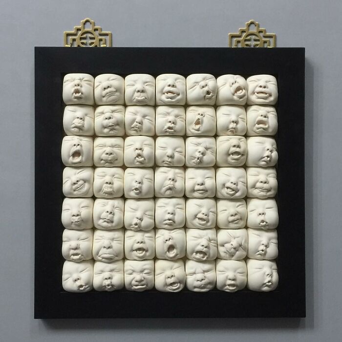 Realism and surrealism in expressive sculptural art featuring multiple emotive faces on a square panel.