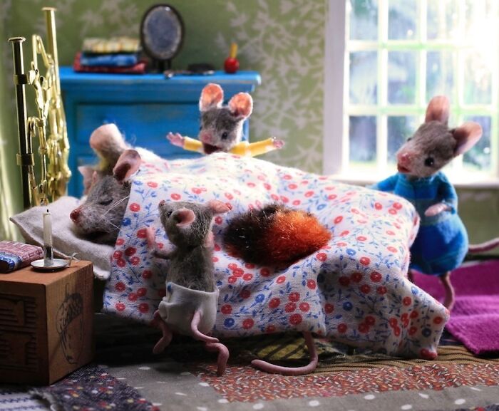 Miniature Mouseland scene by Maggie Rudy with detailed mouse characters under a floral blanket.