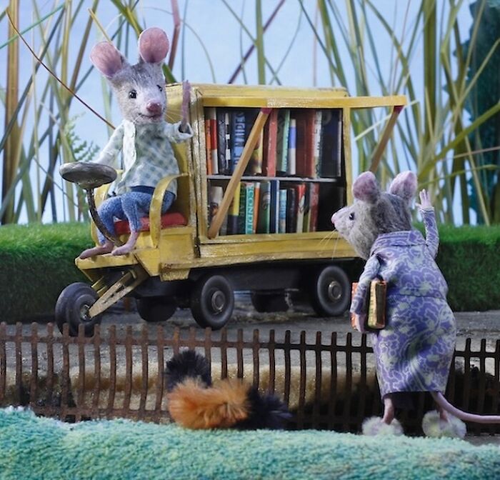 Miniature mice scene from Mouseland, featuring a mouse library cart with detailed books and two mice interacting.