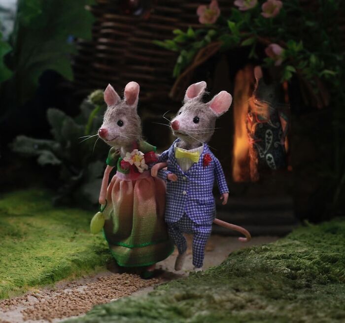 Two mice dressed elegantly in Maggie Rudy's Mouseland, representing a charming miniature world scene.