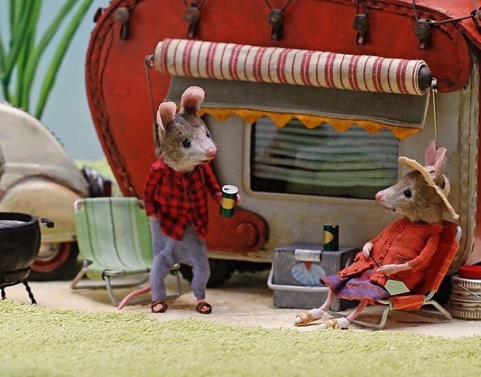 Miniature mice in a detailed setting, relaxing by a caravan, part of Maggie Rudy's charming Mouseland world.