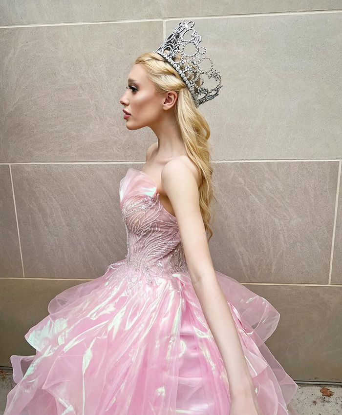 Ariana Grande impersonator Paige Niemann in a pink gown and crown, side profile, sparking weight loss discussions.