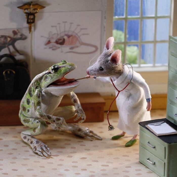 Mouse doctor examines frog patient in a charming and detailed miniature world.