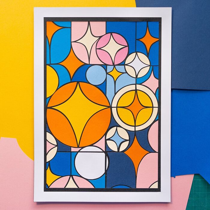 Layered paper illustration featuring colorful geometric shapes in a modern artistic style.