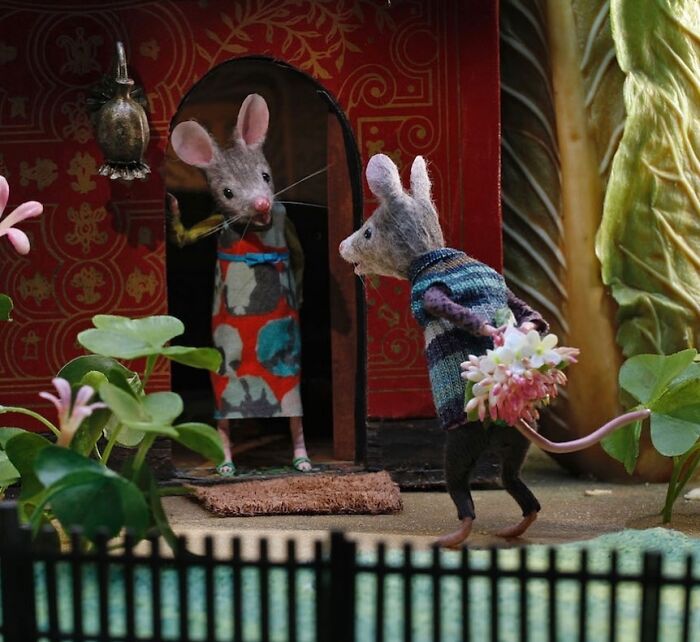 Miniature Mouseland scene by Maggie Rudy showing a mouse offering flowers to another at a detailed doorway.