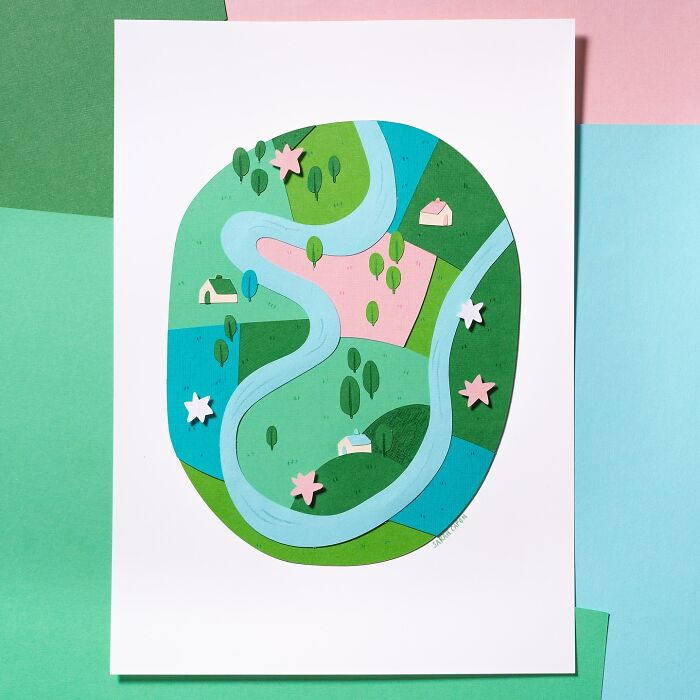 Layered paper art depicting a scenic landscape with a winding river, trees, and houses in a colorful, cute illustration style.