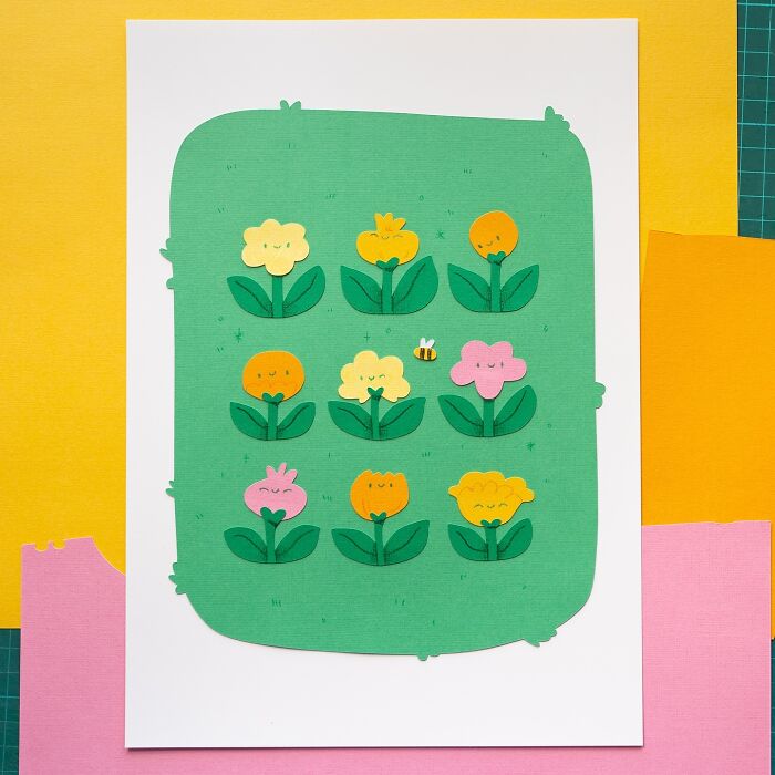 Layered paper artwork of cute flower illustrations with a bee on green background.