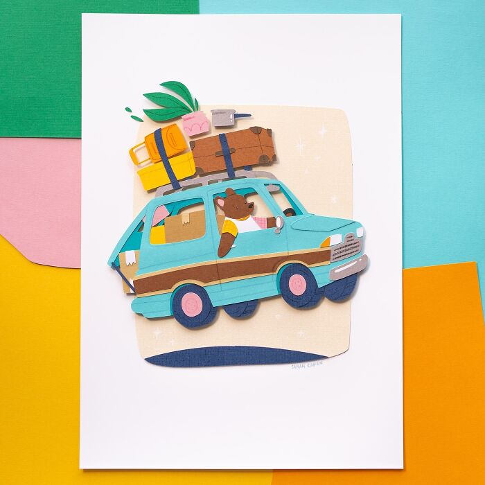 Layered paper illustration of a cute bear driving a packed car with colorful background.